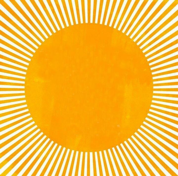This may contain: an orange and yellow sunburst is in the middle of a white background with black dots