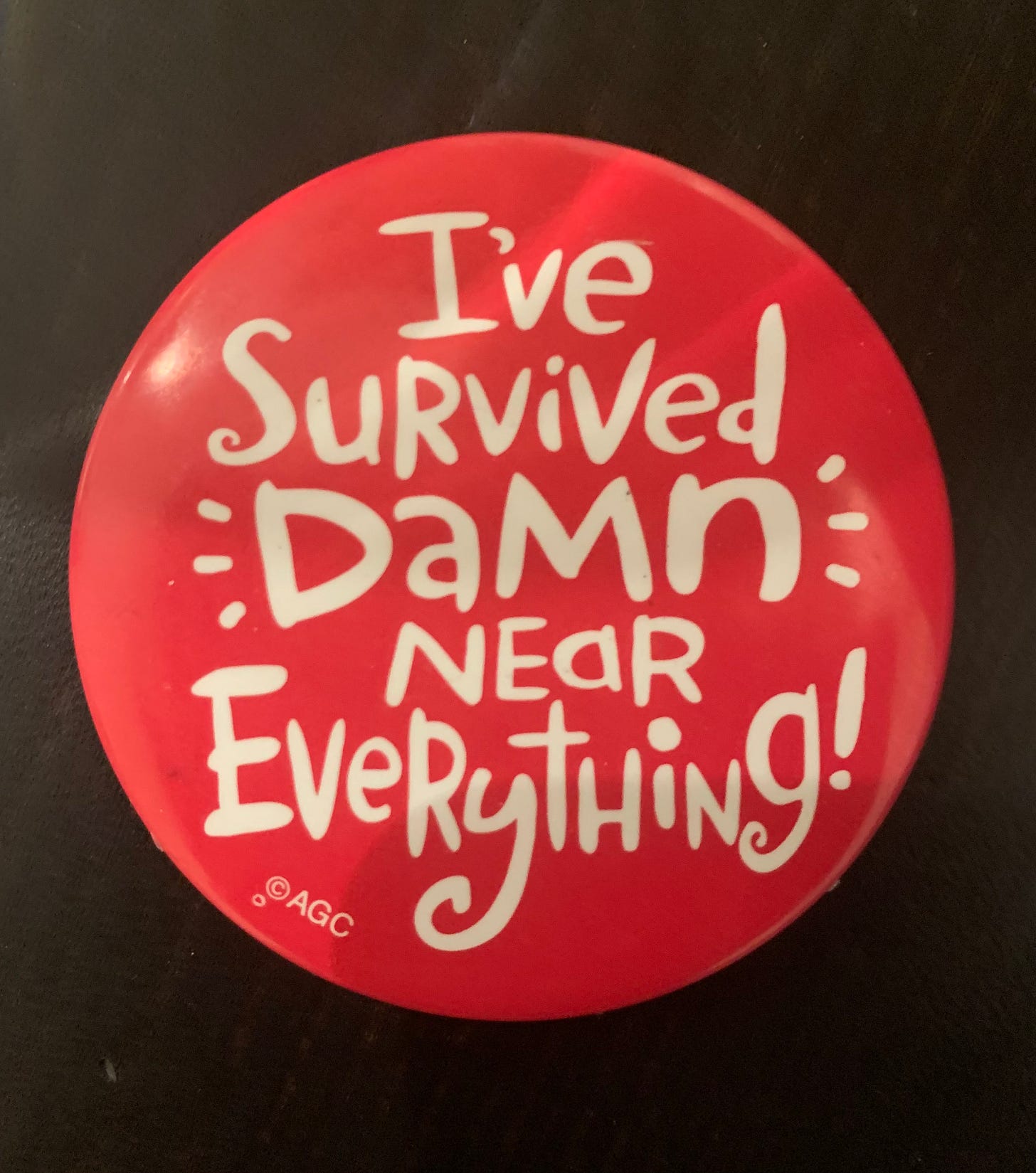 Pin button that reads "I've survived damn near everything!"