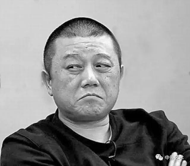 Wang Shuo, looking like he's up to no good, though in fairness that's how he always looks. The original text for the caption below is '真希望在电影里过日子，下一个镜头就是一行字幕：多年以后。'