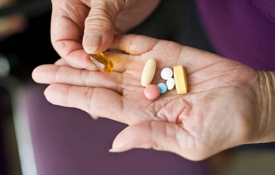 A hand containing several pills