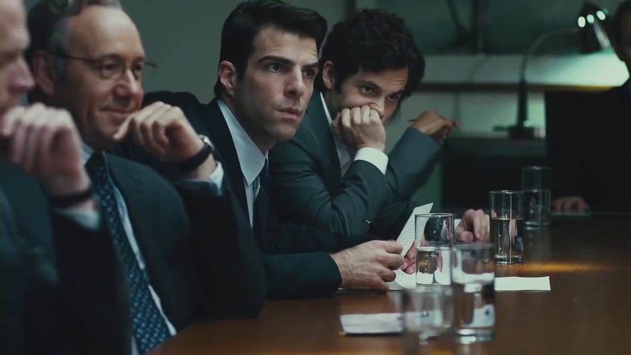 Corporate executives in a tense boardroom meeting scene from the movie Margin Call.