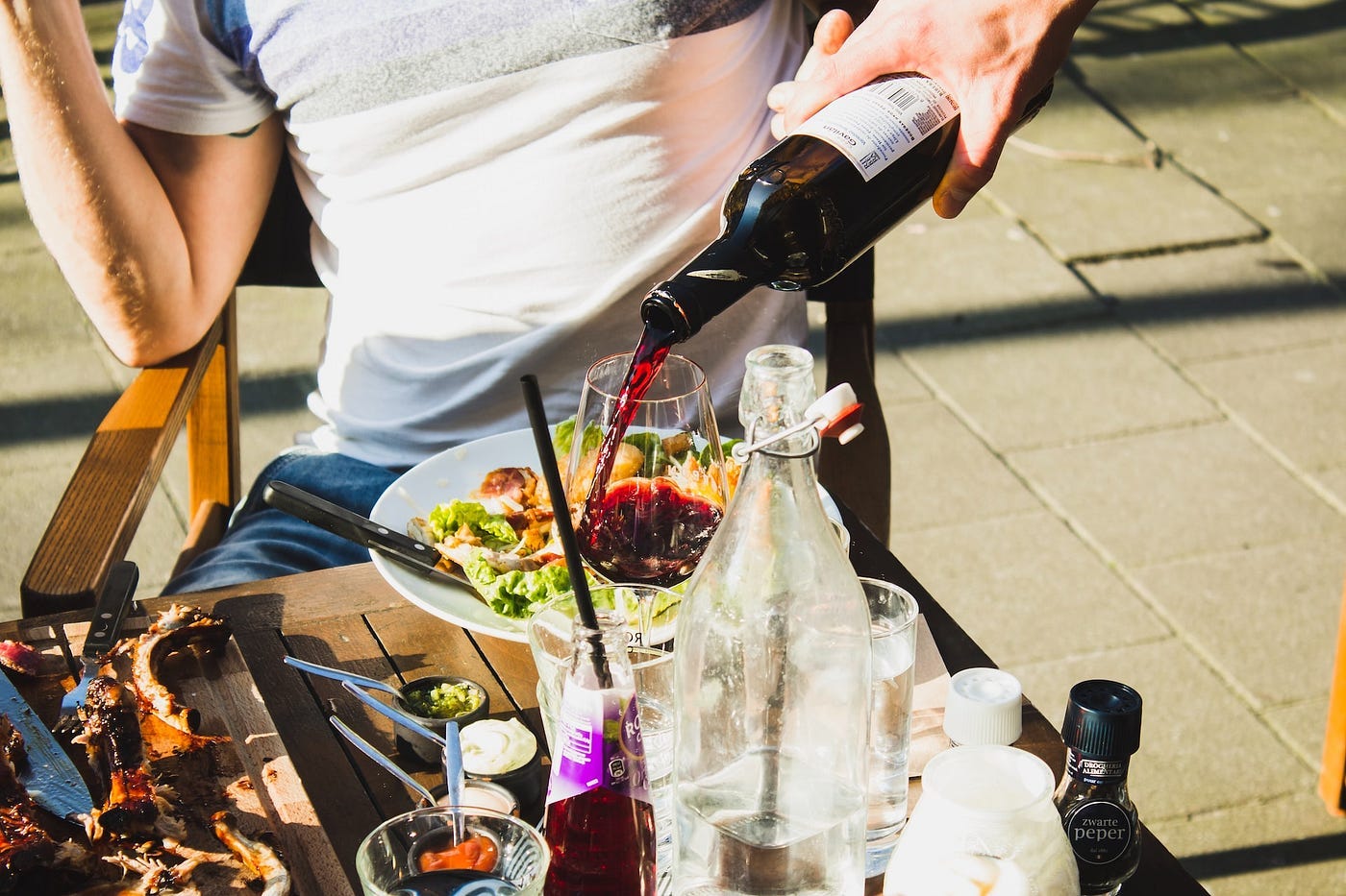 A sommelier pouring a glass of wine for a restaurant guest A sommelier pouring a glass of wine for a restaurant guest