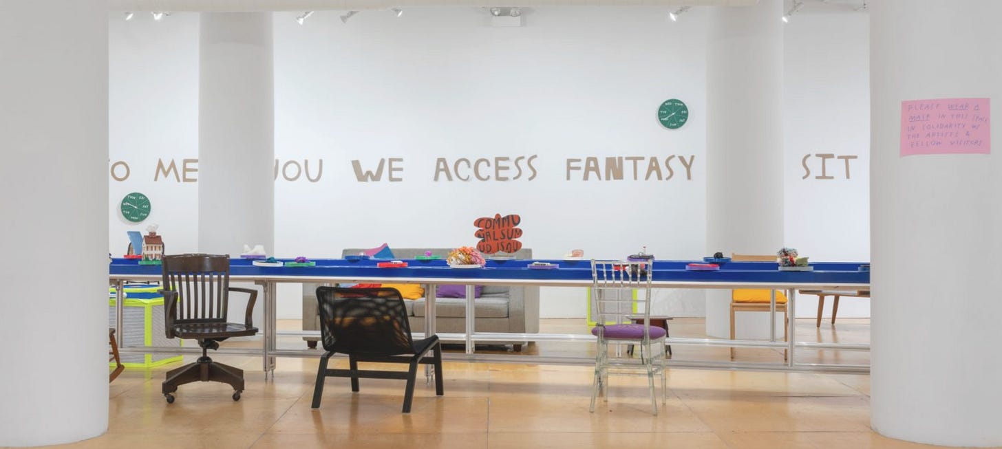 A photo of a white-walled gallery with a blue conveyor belt carrying different small objects with a variety of chairs.