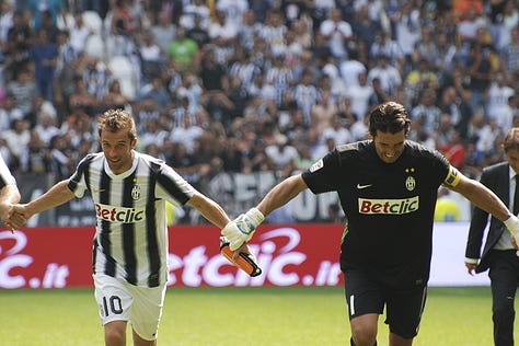 Juventus vs Parma, September 11, 2011: Arturo Vidal celebrates scoring on his debut, Juventus players embrace, fans erupt in celebration, Del Piero and teammates on the pitch, and Gianluigi Buffon giving a thumbs up during the opening match at Juventus Stadium.