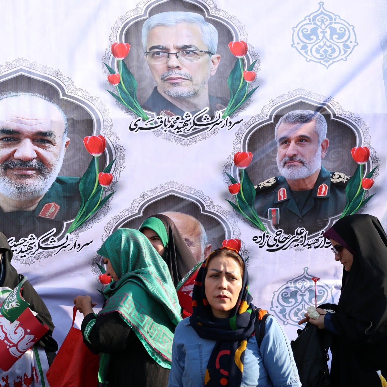 Iranians in front of a billboard showing military leaders during an anti-Israel rally in Tehran on June 14.