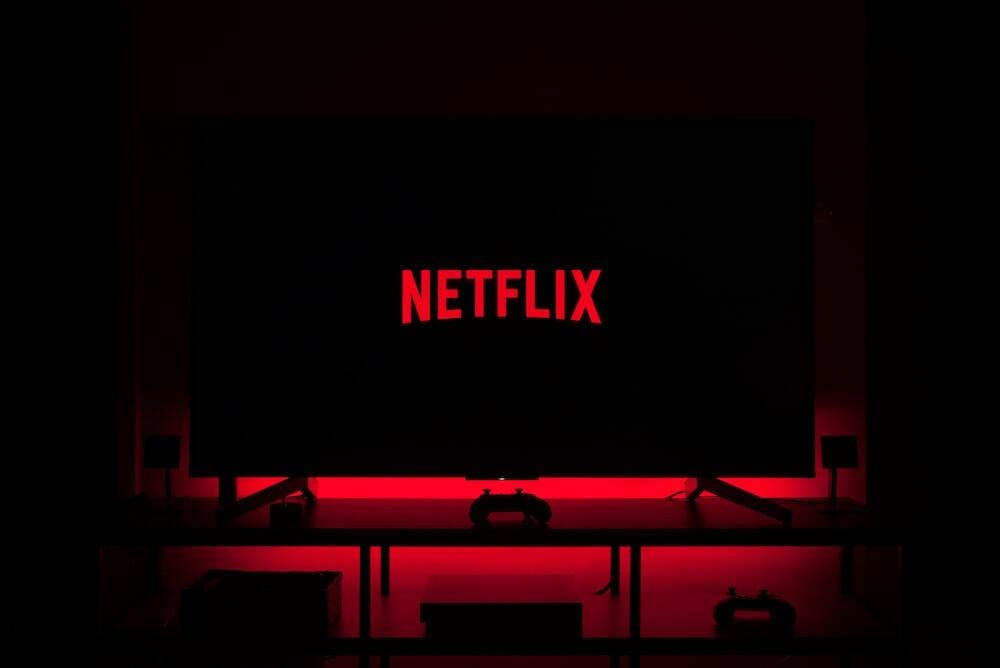 flat screen television displaying Netflix logo flat screen television displaying Netflix logo