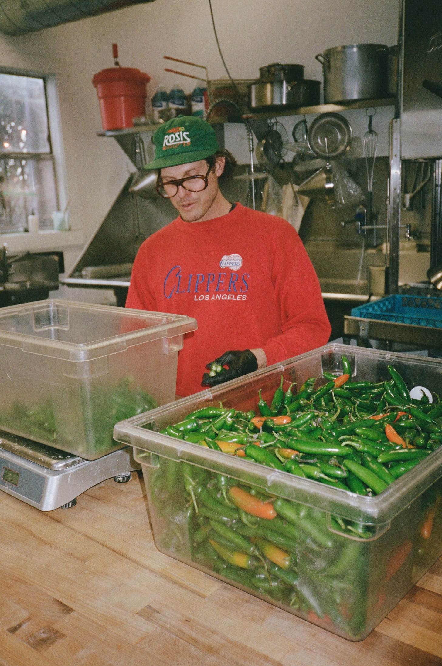 Chris Rosi chops the tops off serrano peppers
