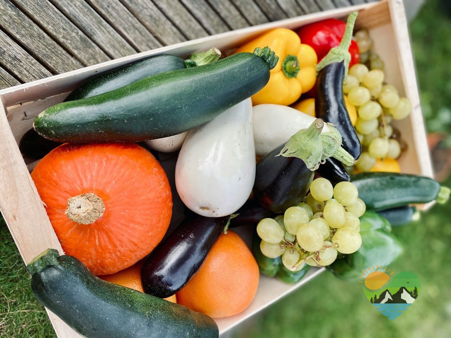 a wooden crate filled with lots of different types of vegetables