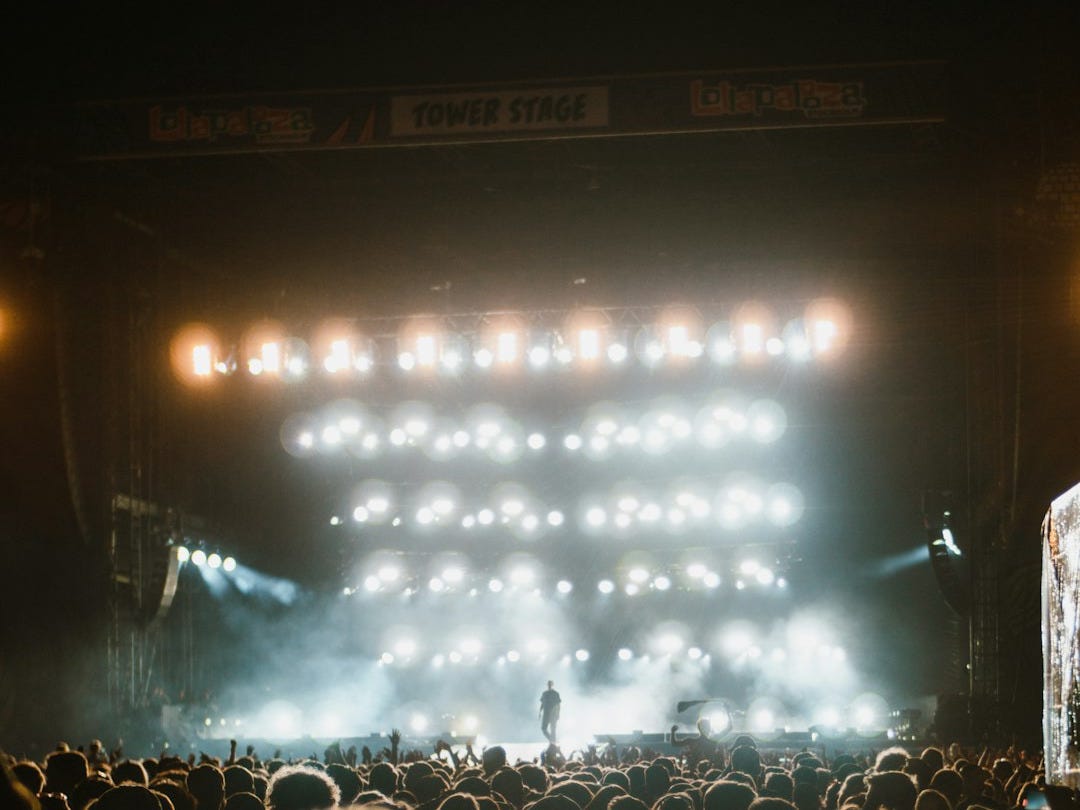 a large crowd of people in front of a stage