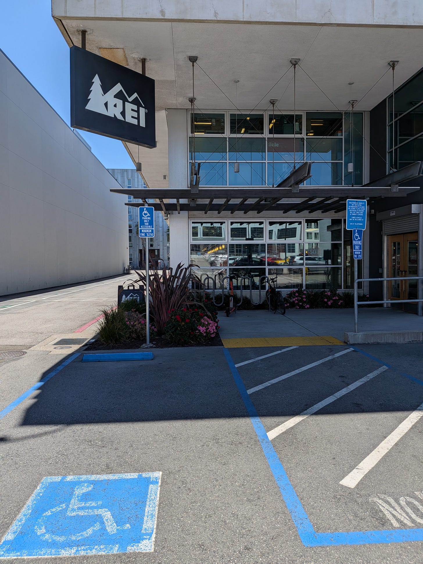 Photograph of the REI outdoor store two showing van accessible parking only right in front of the store.