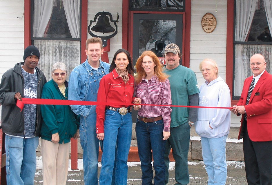 A photo of the ribbon cutting ceremony at Marcy Jo's with Marcy and Don Gary, Joey and Rory Feek, Rita Feek, and officials