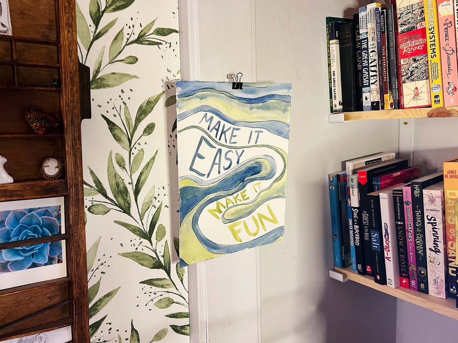 Photograph of graphic novelist K. Woodman-Maynard of her 2026 yearly motto hanging in her studio. 