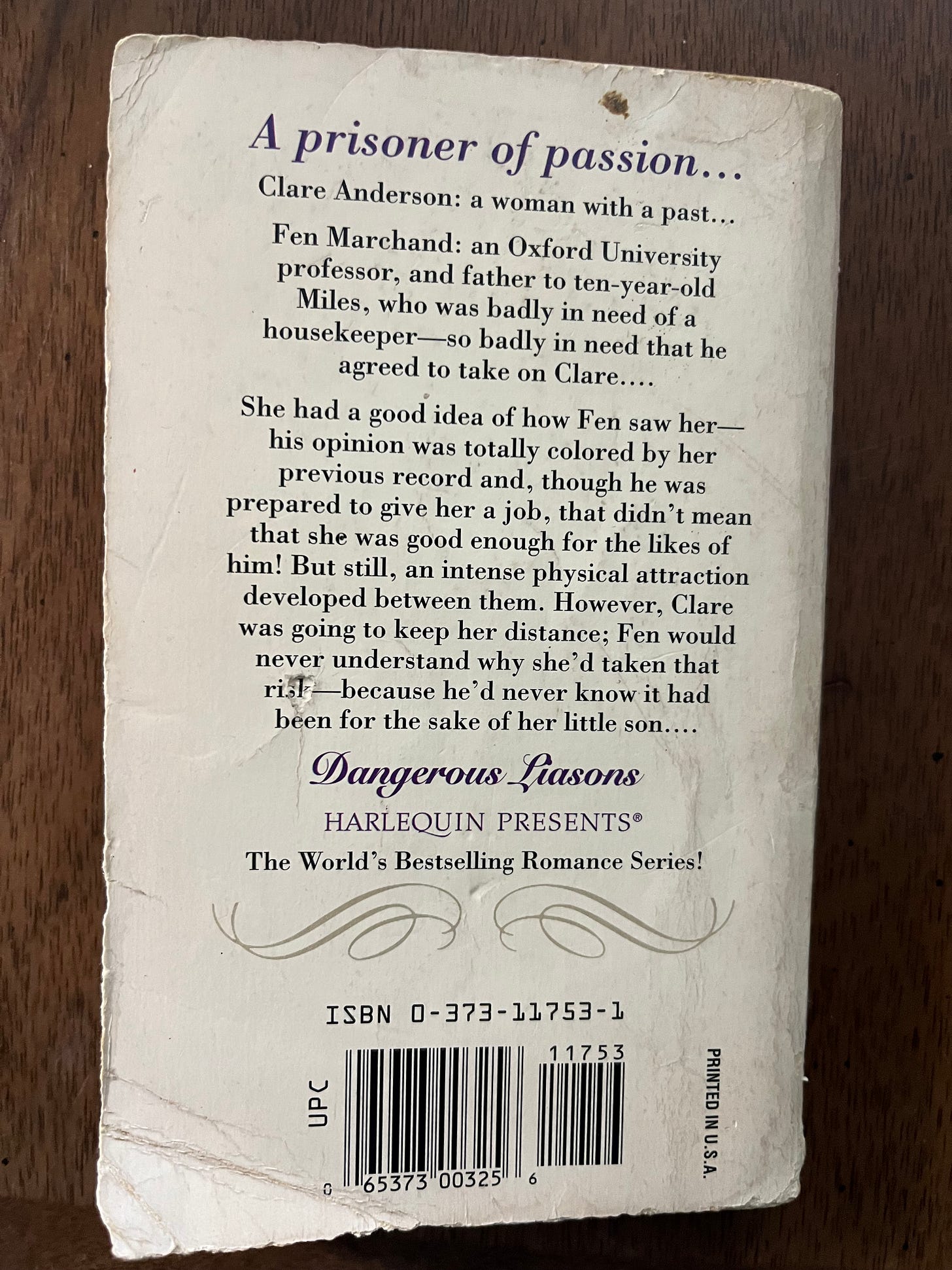 Image of back of book, that reads: A prisoner of passion . . . Clare Anderson: a woman with a past . . . Fen Marchand: an Oxford University professor, and father to ten-year-old Miles, who was badly in need of a housekeeper -- so abdly in need that he agreed to take on Clare . . . She had a good idea of how Fen saw her -- his opinion was totally colored by her previous record and, though he was prepared to give her a job, that didn't mean that she was good enough for the likes of him! But still, an intense physical attraction developed between them. However, Clare was going to keep her distance; Fen would never understand why she'd taken that risk -- because he'd never know it had been for the sake of her little son . . . Image of back of book, that reads: A prisoner of passion . . . Clare Anderson: a woman with a past . . . Fen Marchand: an Oxford University professor, and father to ten-year-old Miles, who was badly in need of a housekeeper -- so abdly in need that he agreed to take on Clare . . . She had a good idea of how Fen saw her -- his opinion was totally colored by her previous record and, though he was prepared to give her a job, that didn't mean that she was good enough for the likes of him! But still, an intense physical attraction developed between them. However, Clare was going to keep her distance; Fen would never understand why she'd taken that risk -- because he'd never know it had been for the sake of her little son . . .