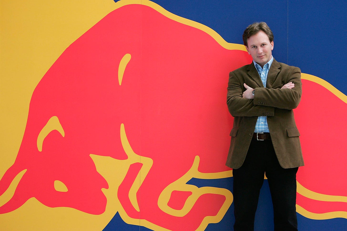 Christian Horner poses for photos in front of a Red Bull logo