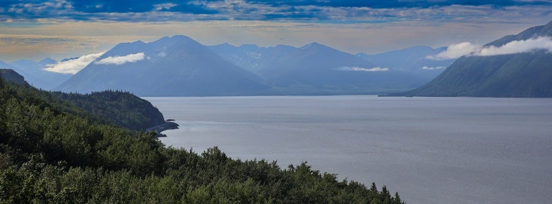 A scenic view of mountains and a body of water A scenic view of mountains and a body of water