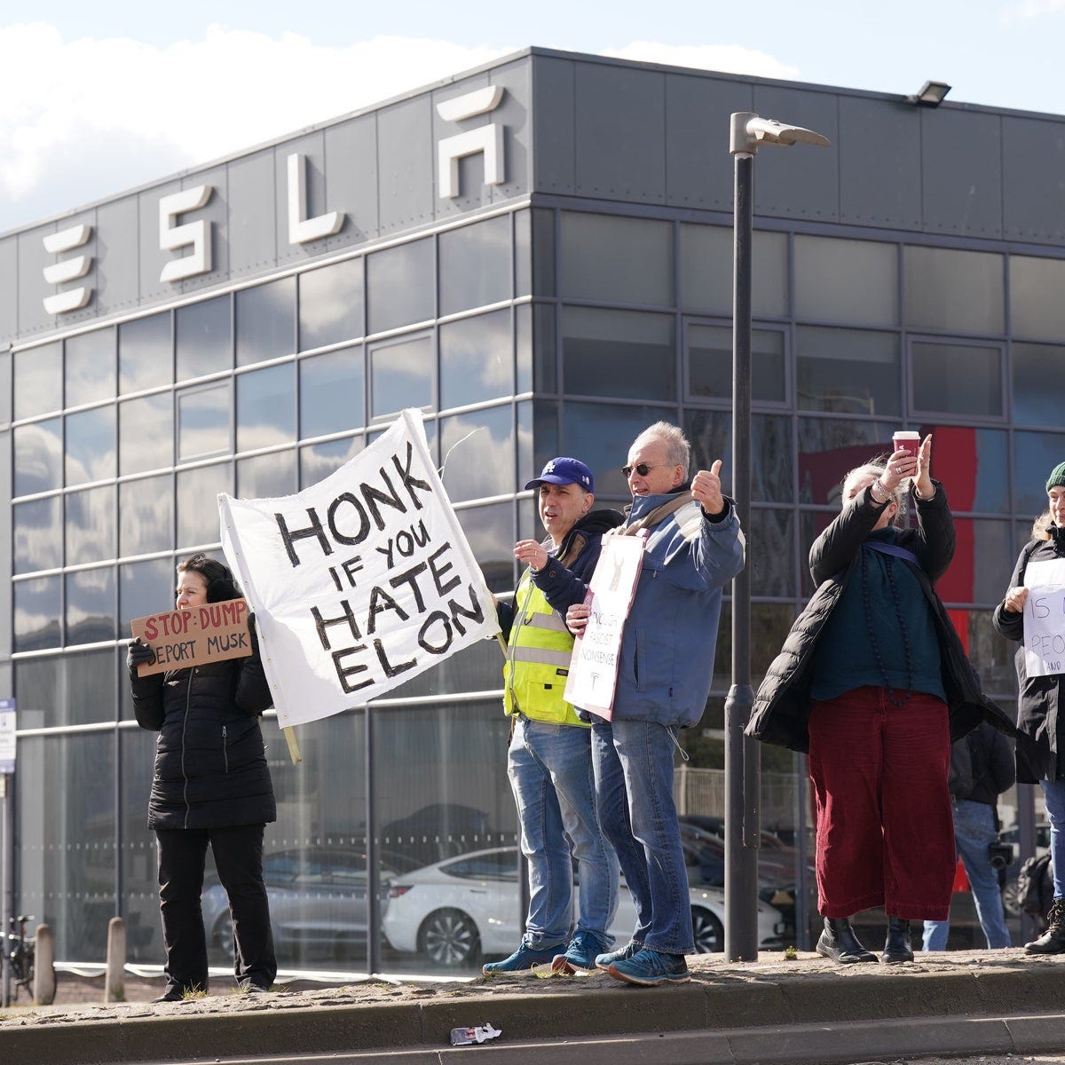 Protesters gathered outside Tesla dealership call for boycott | The  Independent