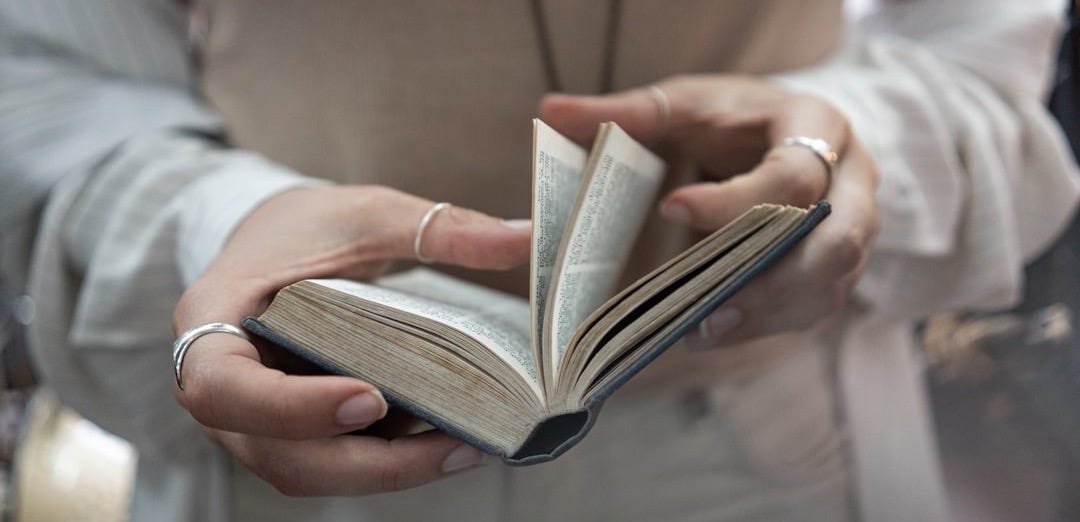 woman flipping over pages of a book