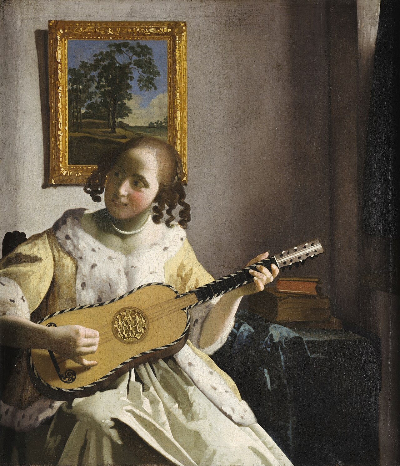 A young woman smiling and strumming a guitar A young woman smiling and strumming a guitar
