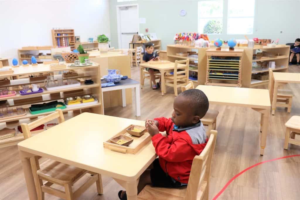 Children working independently in a Montessori Children's House classroom — what is Montessori learning environment