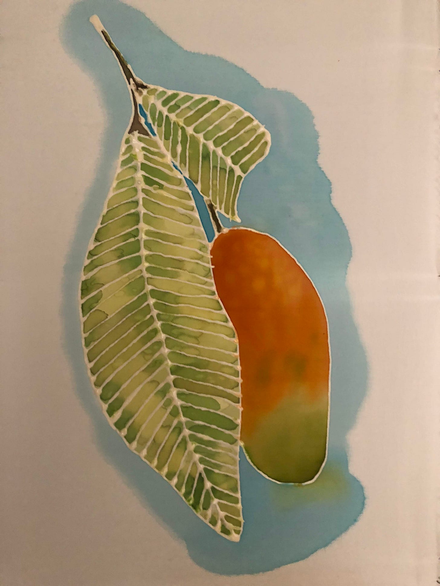 Silk painting showing vibrant mango fruit with single green leaf using serti resist technique