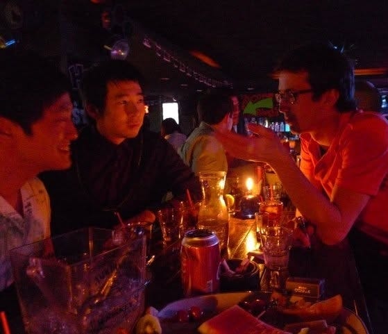 Guys drinking at a bar.