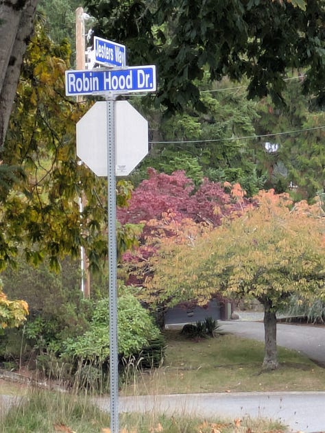 Scenes from Vancouver suburbia. One picture is of a sign that says Robin Hood Drive. One has a wooden menhir that says Sherwood Forest". The third has a deer looking warily at the camera