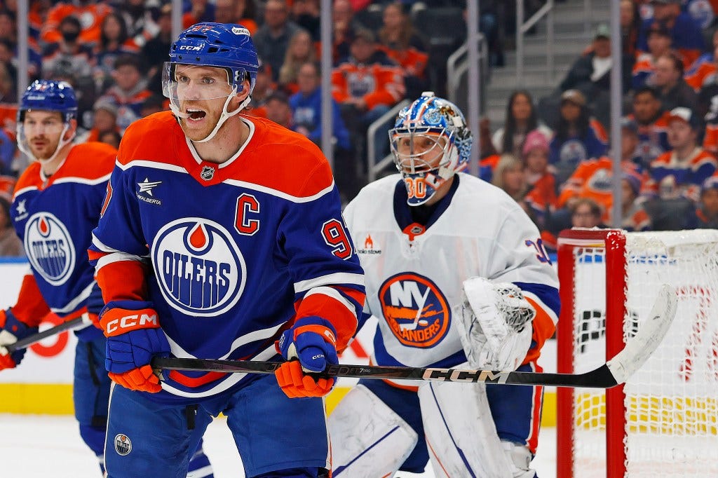 Connor McDavid looks for a loose puck as Ilya Sorokin watches the action during the Islanders' OT loss. Connor McDavid looks for a loose puck as Ilya Sorokin watches the action during the Islanders' OT loss.