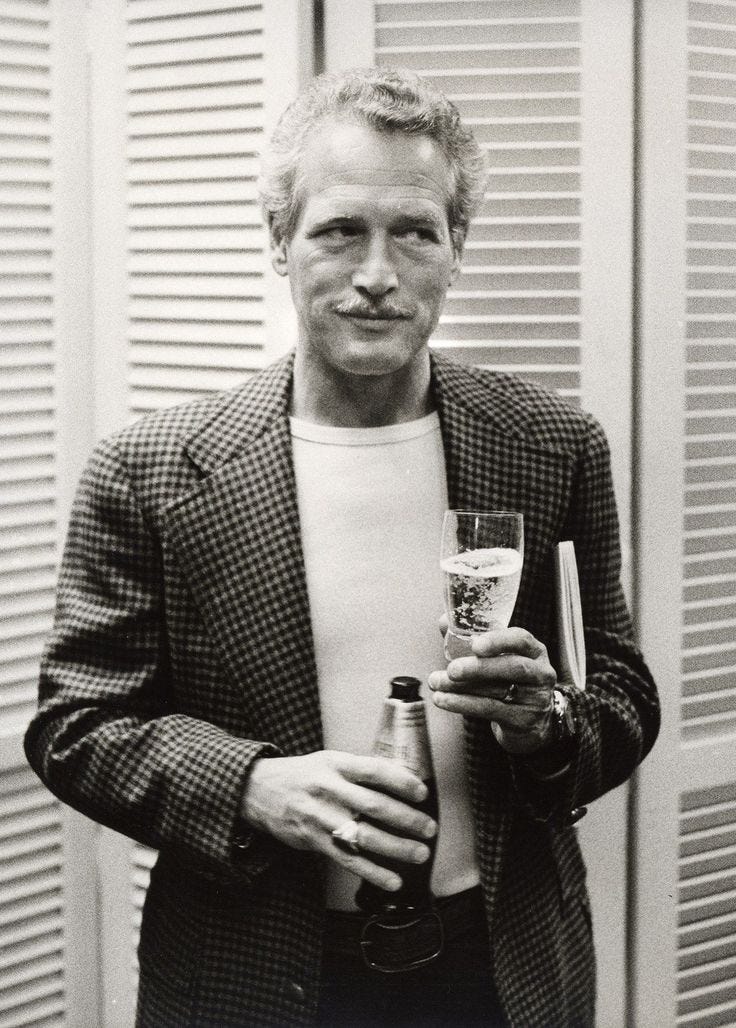 This may contain: a black and white photo of a man holding a beer