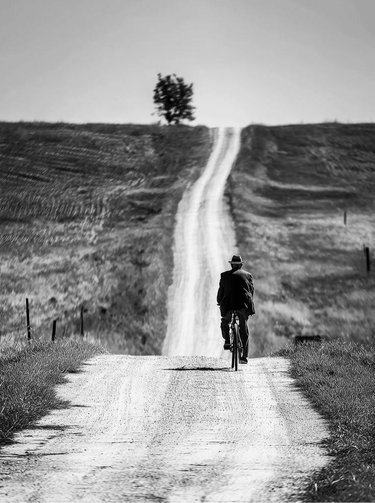 May be a black-and-white image of motorcycle and road