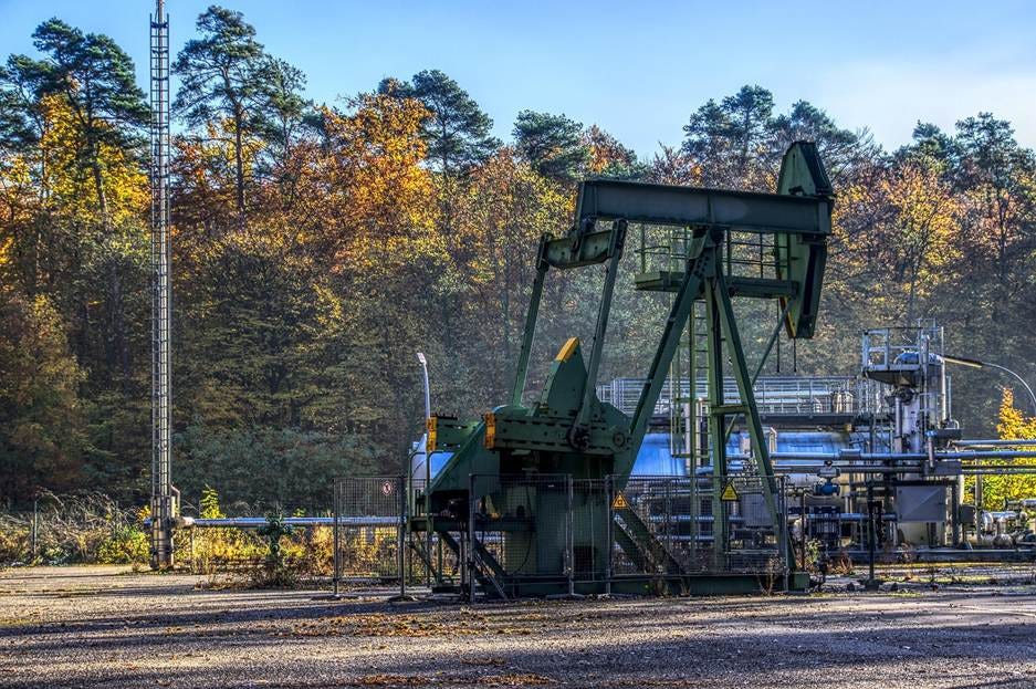 A green oil rig in a forest

AI-generated content may be incorrect.