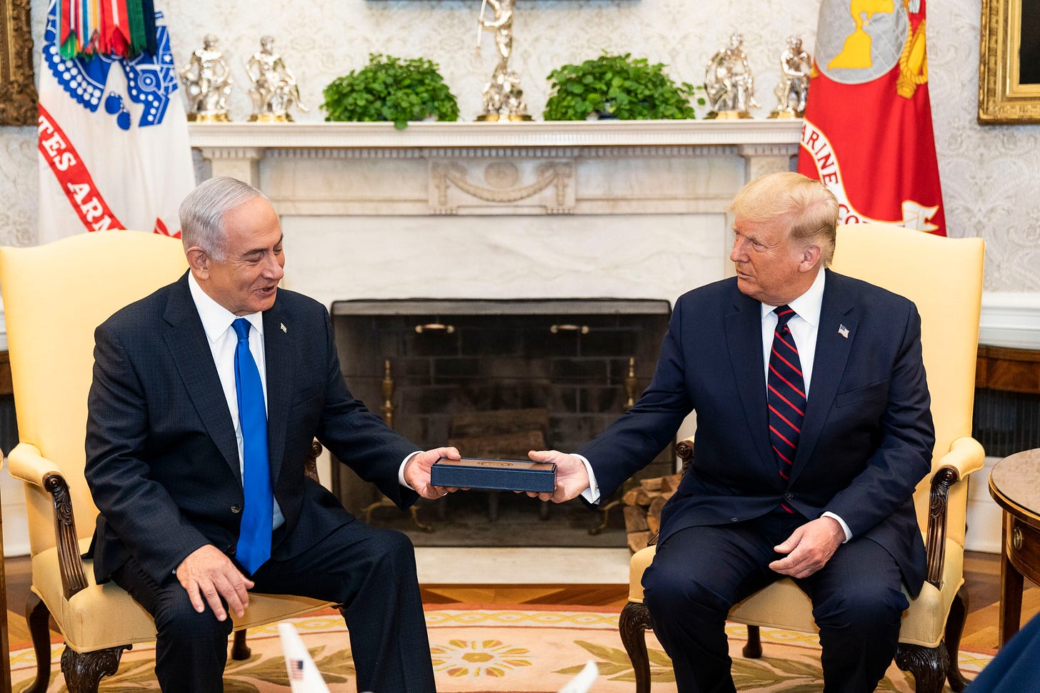 Netanyahu and Trump sitting together in suits in formal setting; both holding one end of the Abraham accords, 2020 Netanyahu and Trump sitting together in suits in formal setting; both holding one end of the Abraham accords, 2020