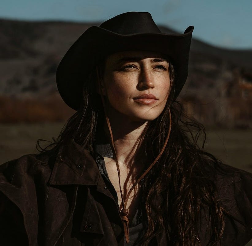 A woman with long hair wearing a cowboy hat A woman with long hair wearing a cowboy hat