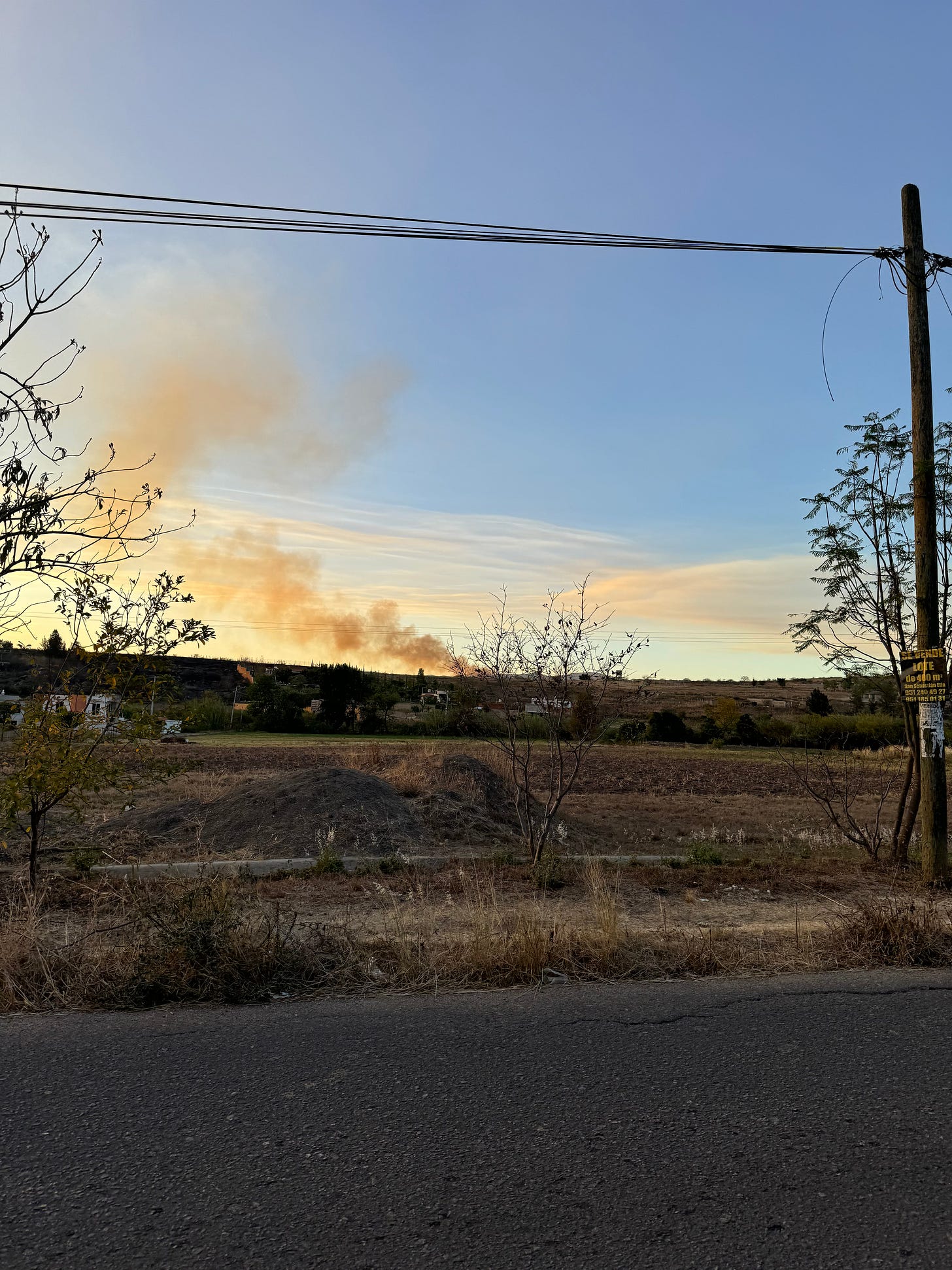 A photo of a plume of fire in rising from the horizon.