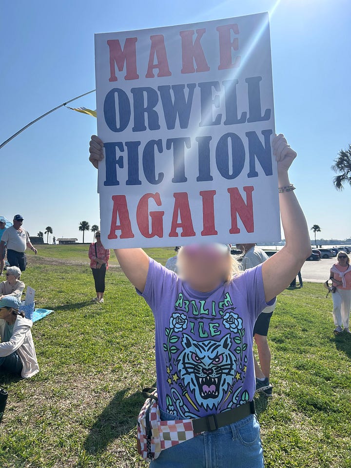 Clockwise from top left: two protesters hold a sign that reads "America, Stop Putting Corporations First." The stop is a stop sign; A protester in a white tiger t-shirt holds a sign that says "Make Orwell Fiction Again"; a protester with their back to us holds a sign that reads "I prefer ICE in my coffee," not in the streets." a woman in a white baseball hat, a skirt and red shoes holds a sign that reads "War! What Is It Good For? Distracting from The Epstein Files. (Sing It Again!).