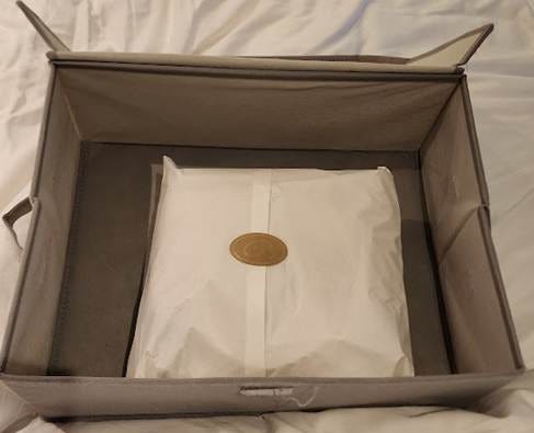 A white bag in a box

AI-generated content may be incorrect.