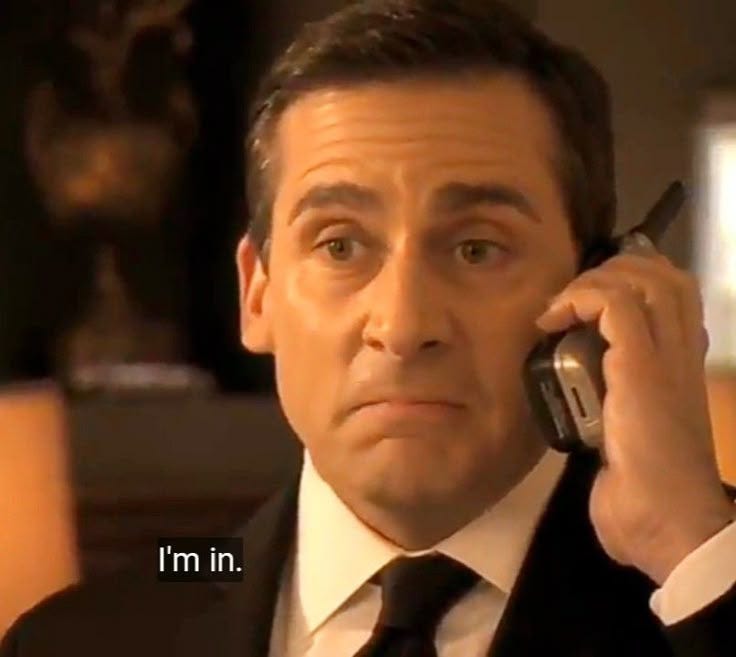 This may contain: a man in a suit talking on a cell phone