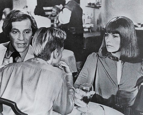 Black and white photographs that are old Hollywood movie stills that have had a lesbian figure collaged into the scene.