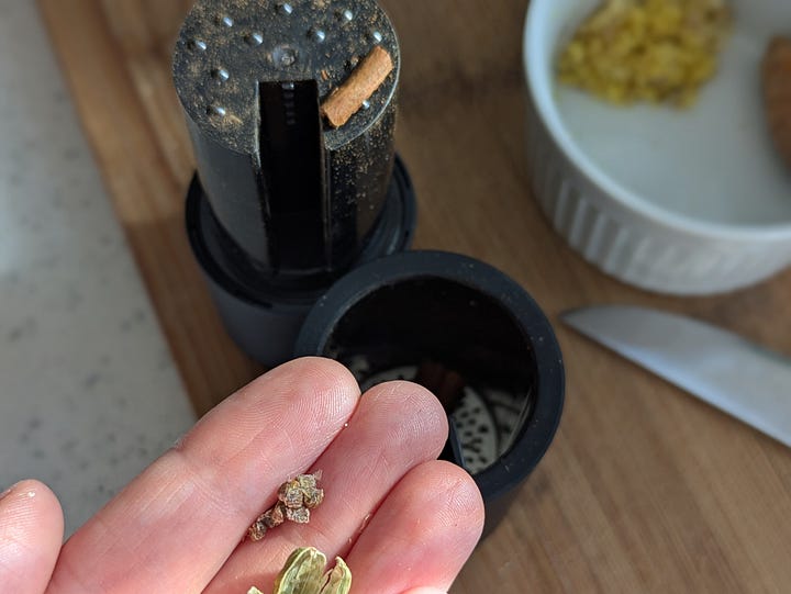 Fresh grated ginger with whole cinnamon, cardamom and turmeric.