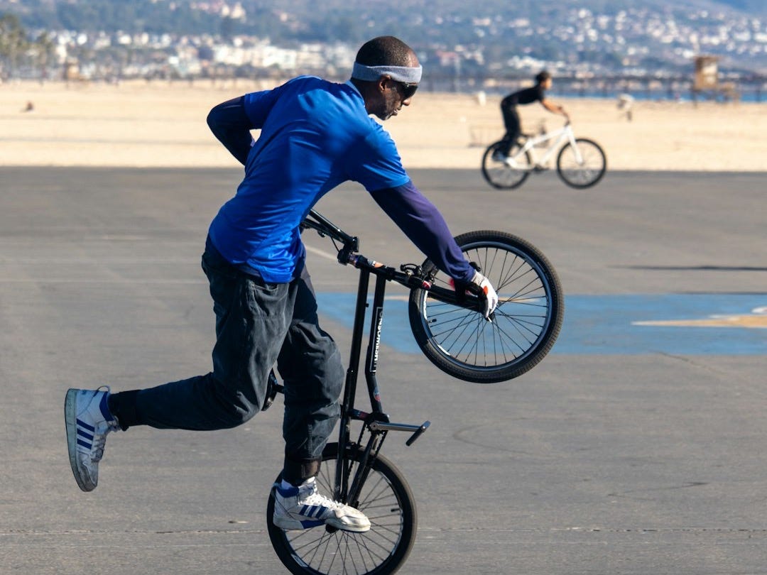 A man is doing a trick on a bicycle A man is doing a trick on a bicycle