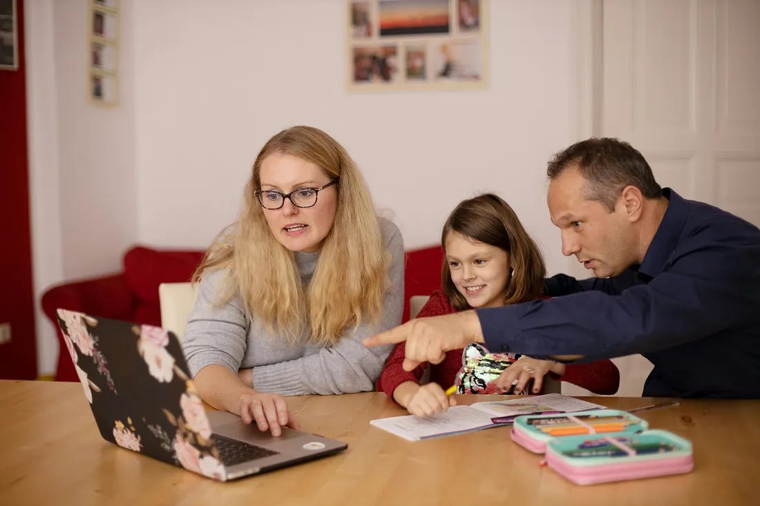 Parents helping their child with homework