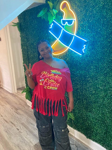 Left to right: Black woman throws up the peace side behind a forrest green plant back drop wearing a red distressed t-shirt that read "Birthday Cousin Cruise Crew". Black woman points toward black and blue sign that reads "Betty's Soul" a restaurant in Miami, Florida. Black Woman poses in front of turquoise ocean in a multicolor matching shirt and short set