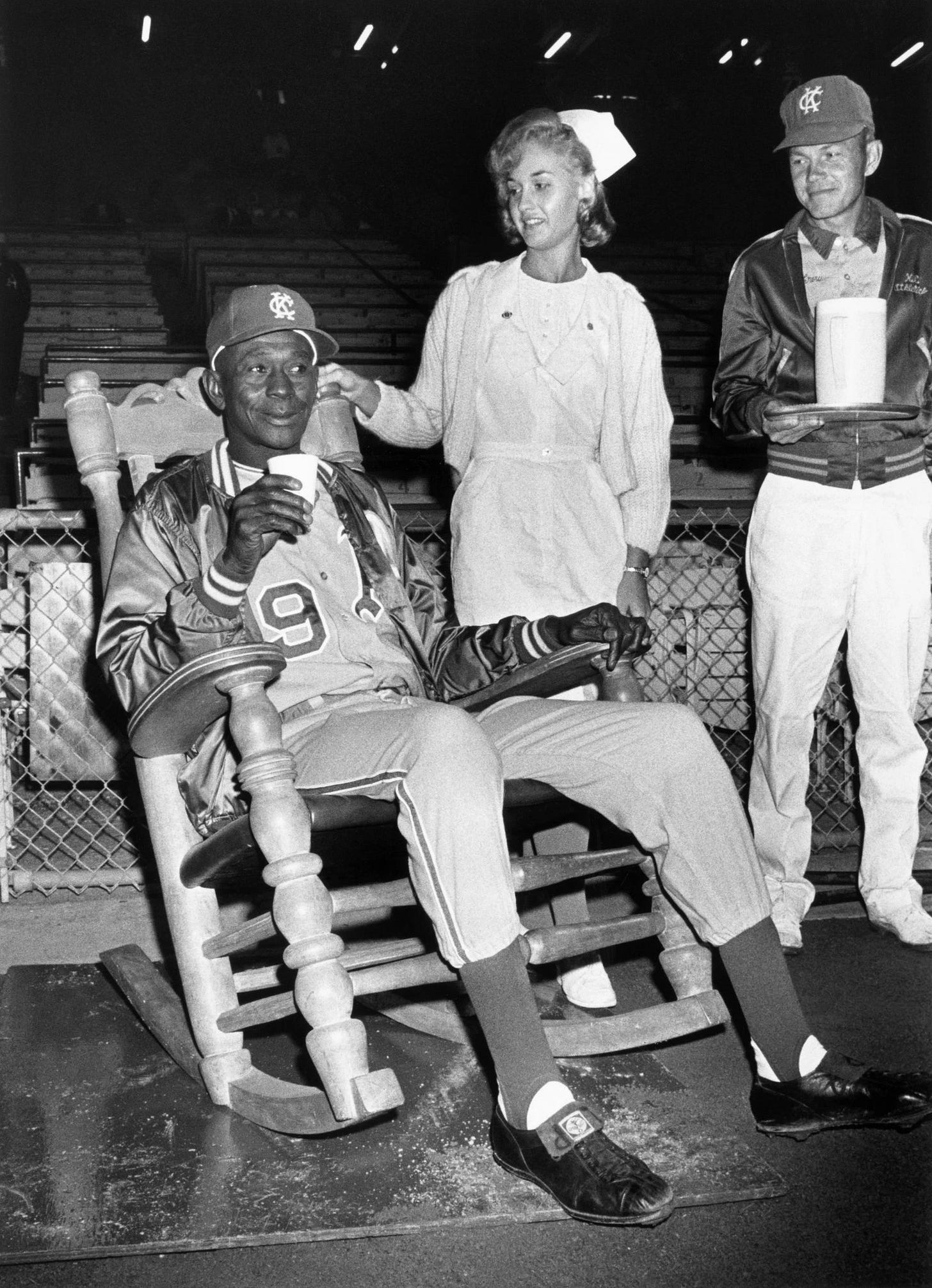 Paige in rocking chair, attended by his personal nurse and water boy.