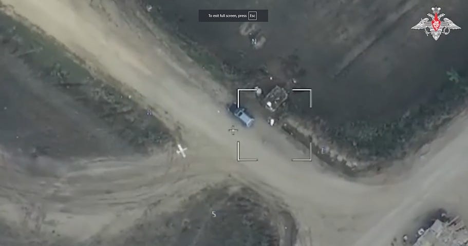 A Lancet loitering strike drone – the small white aircraft to the left of the vehicle in the center of the image – in its final moment of flight prior to impact with a target vehicle. This is a screenshot from video footage recorded by a Russian ISR drone observing the engagement, one that likely identified this target for a Lancet to attack. A Lancet loitering strike drone – the small white aircraft to the left of the vehicle in the center of the image – in its final moment of flight prior to impact with a target vehicle. This is a screenshot from video footage recorded by a Russian ISR drone observing the engagement, one that likely identified this target for a Lancet to attack.