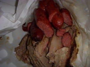 My sausage nestling up to Ronnie's brisket. It can't get away.