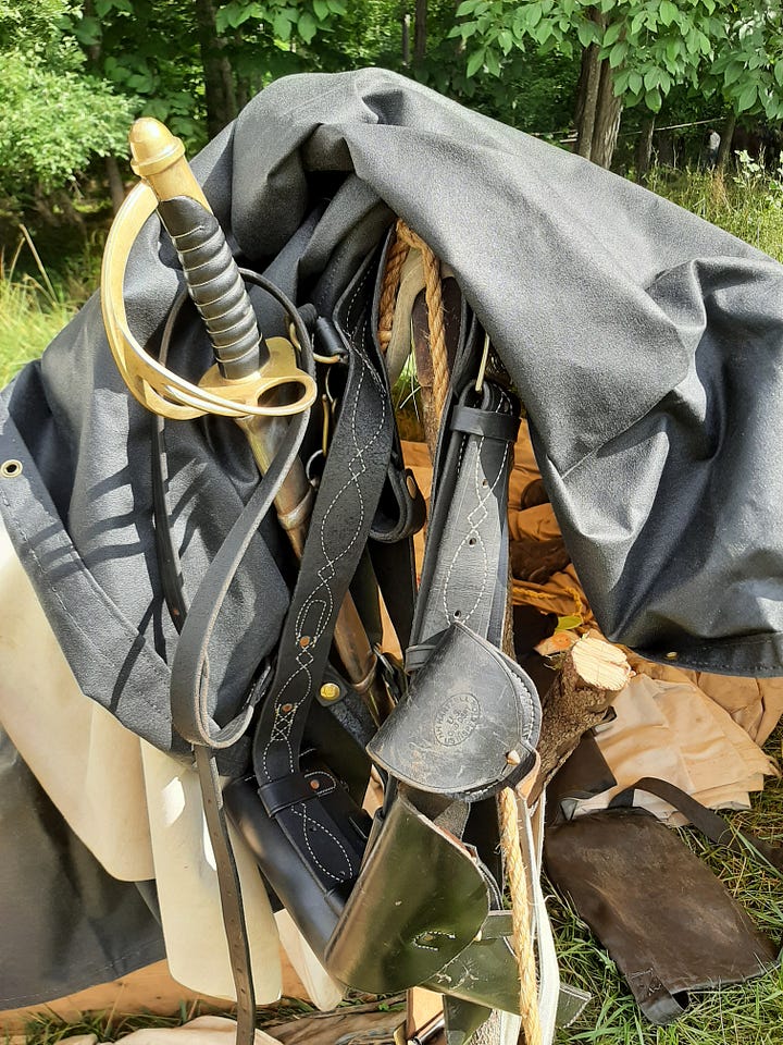 The leg, boot and sword of a cavalry reenactor, along with the different leather equipment they use.