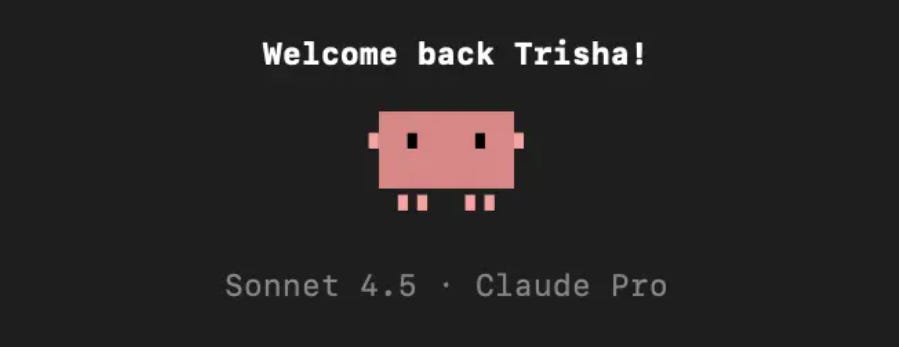 Screenshot showing a black screen with white text saying “Welcome back Trisha!” and a small pink pixel character below, labeled “Sonnet 4.5 · Claude Pro.”