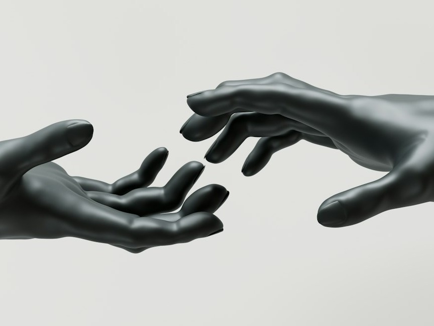 A couple of hands reaching for each other A couple of hands reaching for each other