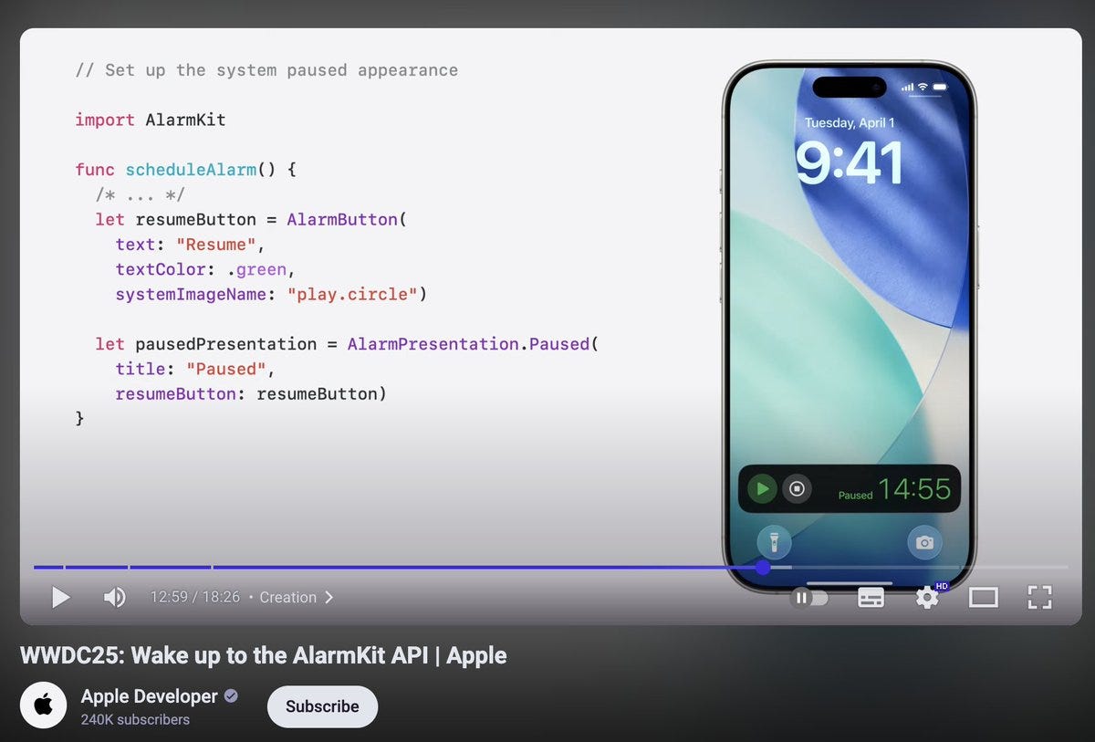 Screenshot displays Swift code snippet importing AlarmKit, defining functions for pause and resume buttons with system image play circle, and setting paused presentation to AlarmPresentation.paused, alongside an iPhone screen showing a paused timer at 9:41 with play button, and a video player thumbnail labeled Watch Set up the system paused appearance to AlarmKit at Apple with developer subscribe button.