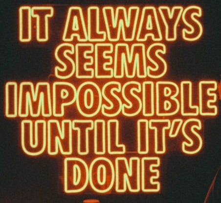a neon sign that says it always seems impossible until it's done a neon sign that says it always seems impossible until it's done