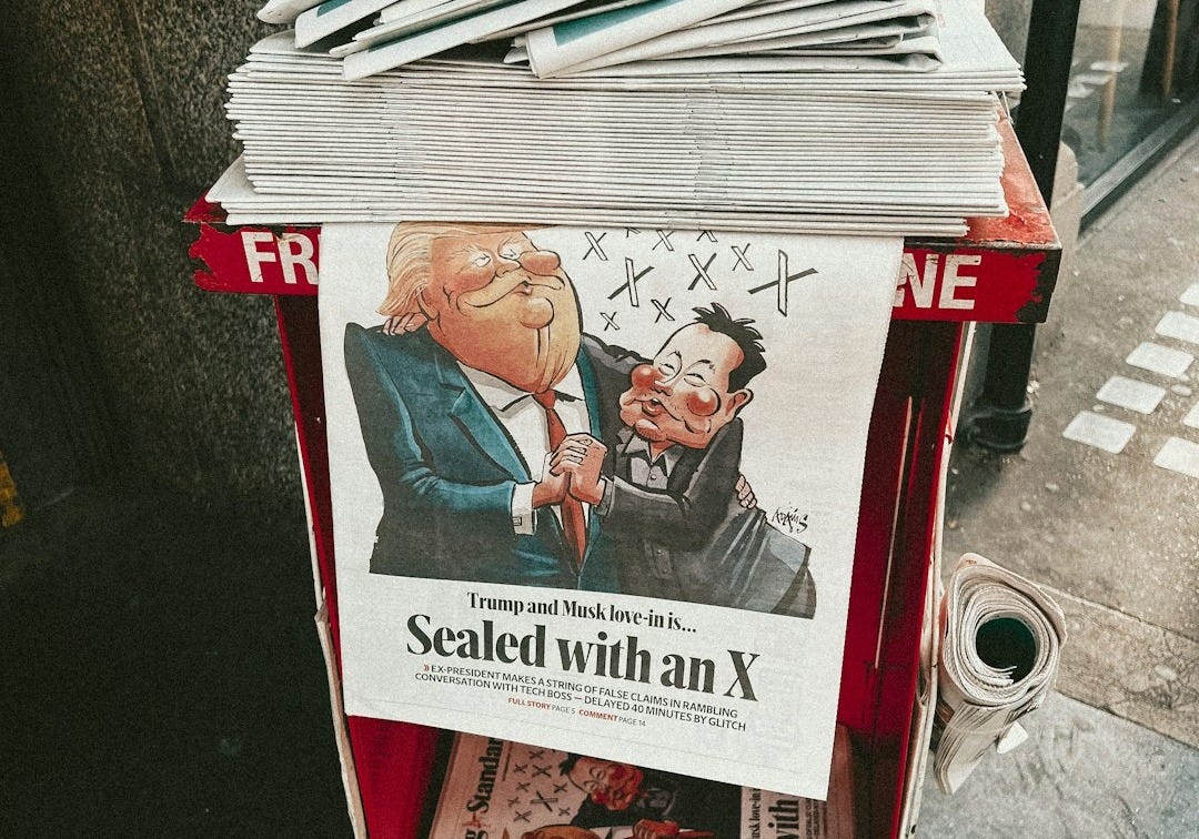 A newspaper stand with a bunch of newspapers on top of it